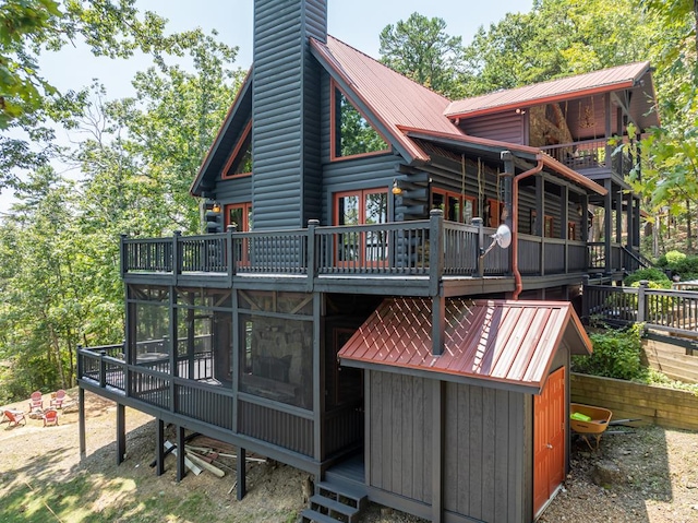 1363 NE Foxhound Trl, Ranger, GA 30734 - back of house with metal roof, a chimney, and a wooden deck