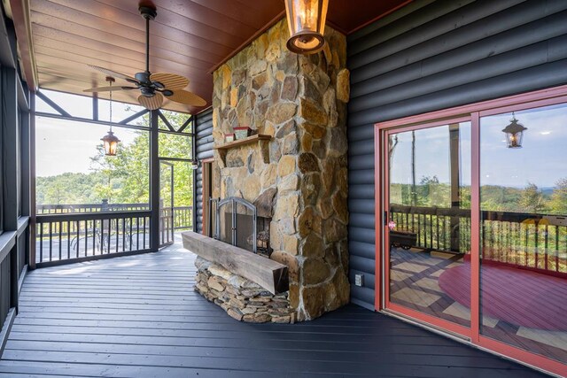 exterior space featuring a fireplace and ceiling fan