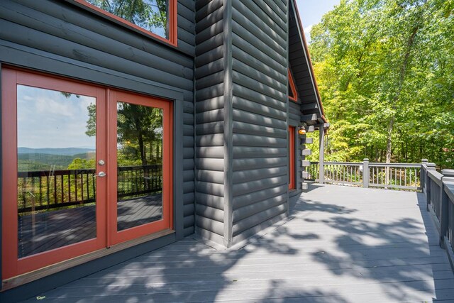 deck with french doors and a mountain view