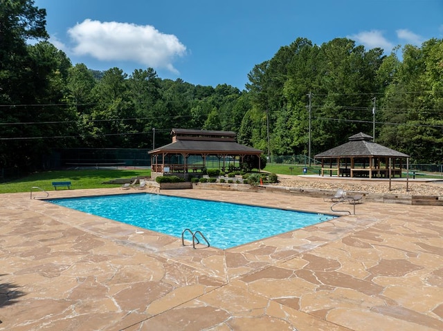 1363 NE Foxhound Trl, Ranger, GA 30734 - community pool featuring a gazebo, a patio area, and a wooded view