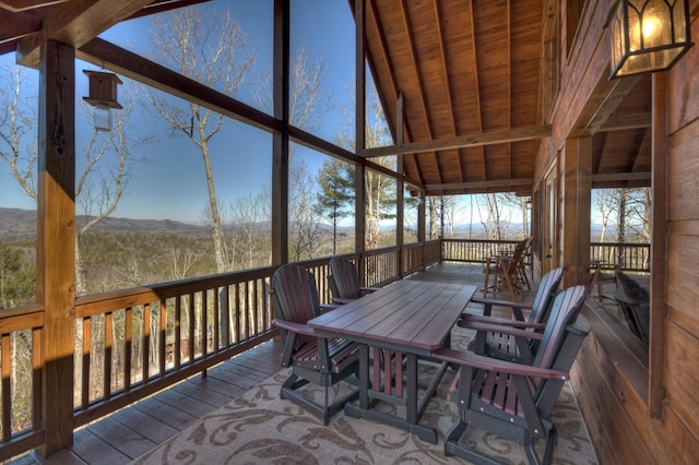 sunroom / solarium featuring wooden ceiling and vaulted ceiling