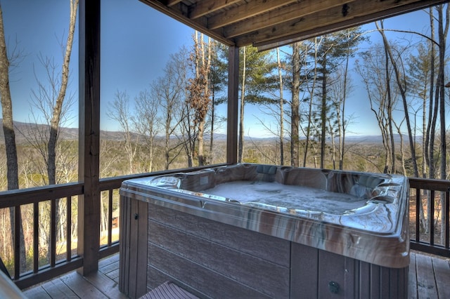 wooden terrace featuring a hot tub