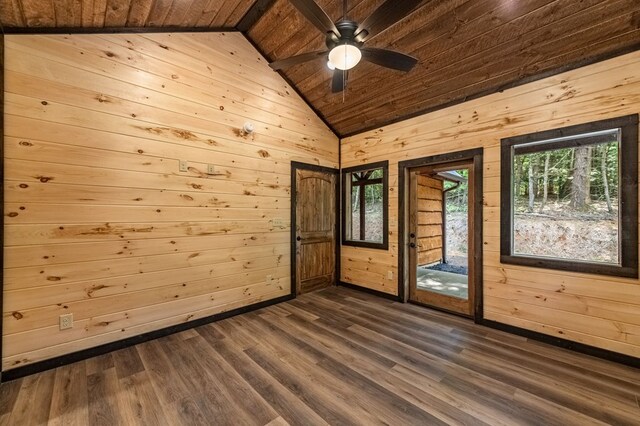 empty room featuring plenty of natural light, ceiling fan, wooden ceiling, and concrete flooring