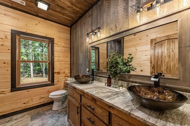 interior space with ceiling fan, wooden ceiling, and wooden walls