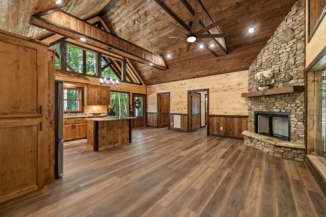 kitchen with wood ceiling, high vaulted ceiling, dark wood-type flooring, and stainless steel refrigerator