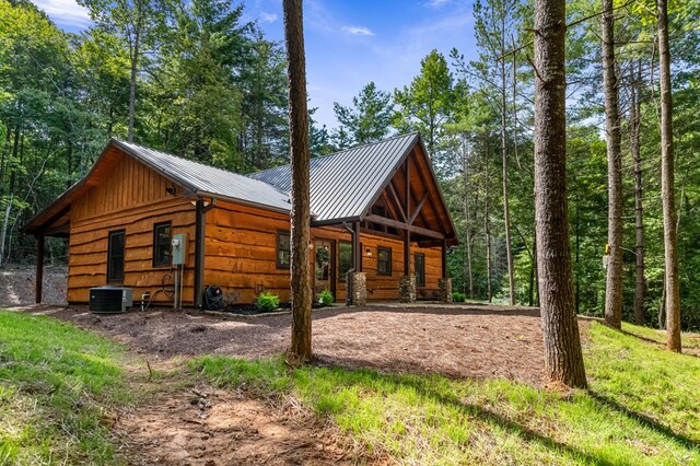 rear view of property featuring a patio area and central AC