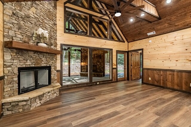 kitchen featuring wooden ceiling, dark hardwood / wood-style floors, high vaulted ceiling, and a fireplace