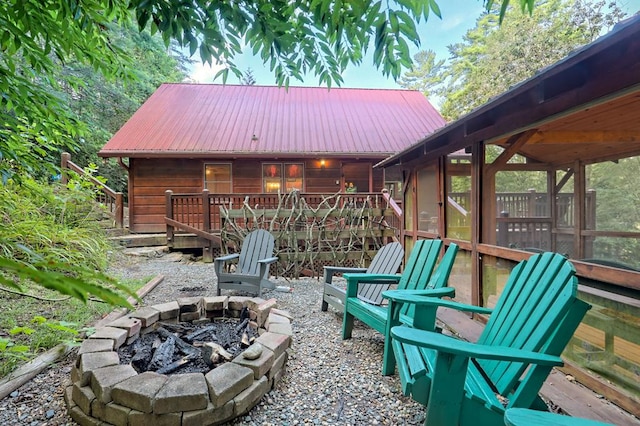 view of patio / terrace featuring a fire pit and a deck