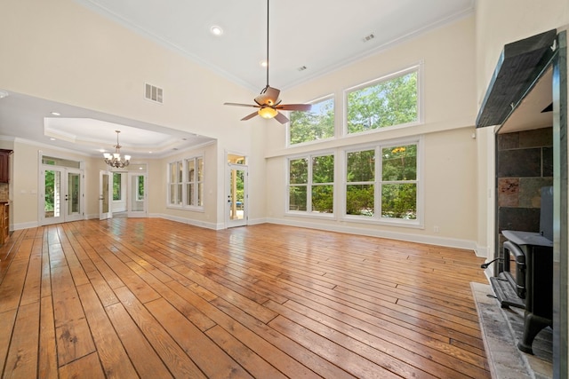705 Brown Deer Dr, Talking Rock, GA 30175 - unfurnished living room with a wood stove, light wood-style floors, crown molding, a chandelier, and a ceiling fan