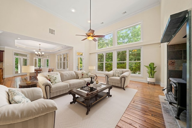 705 Brown Deer Dr, Talking Rock, GA 30175 - living area featuring a wood stove, light wood-type flooring, crown molding, a chandelier, and ceiling fan