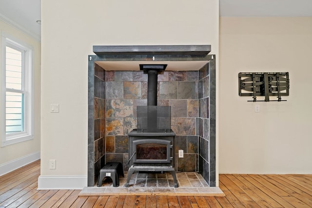 705 Brown Deer Dr, Talking Rock, GA 30175 - detailed view of wood finished floors, a wood stove, and crown molding