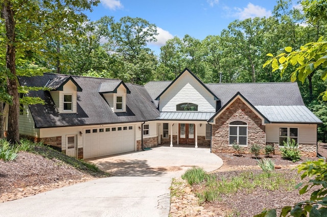 705 Brown Deer Dr, Talking Rock, GA 30175 - view of front of home with stone siding, an attached garage, driveway, a standing seam roof, and french doors