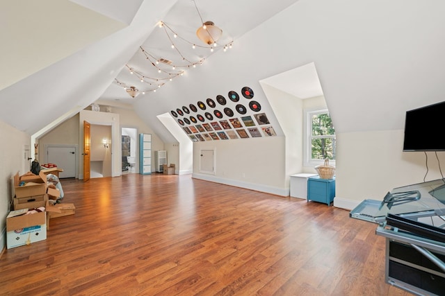 705 Brown Deer Dr, Talking Rock, GA 30175 - unfurnished living room featuring lofted ceiling, wood finished floors, and a chandelier