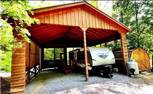 view of parking featuring a storage shed and a carport