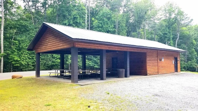 surrounding community with a lawn and a view of trees