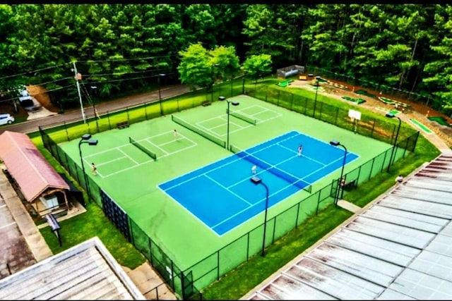 view of tennis court featuring fence