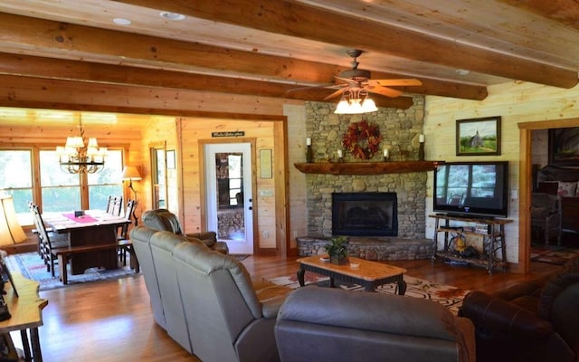 living room with a fireplace, beamed ceiling, wooden walls, and light wood-type flooring