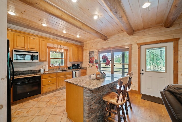 kitchen with light wood-type flooring, a wealth of natural light, beam ceiling, and black appliances