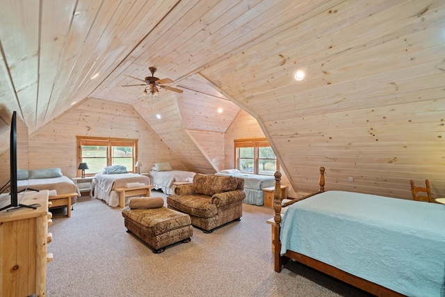 carpeted bedroom featuring ceiling fan, wood ceiling, wooden walls, and lofted ceiling