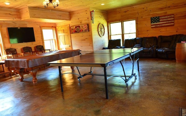 playroom with plenty of natural light, wood walls, and wooden ceiling