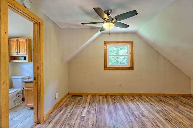 bonus room featuring ceiling fan, hardwood / wood-style floors, and vaulted ceiling