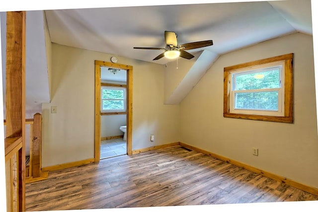 bonus room with wood-type flooring, vaulted ceiling, and ceiling fan