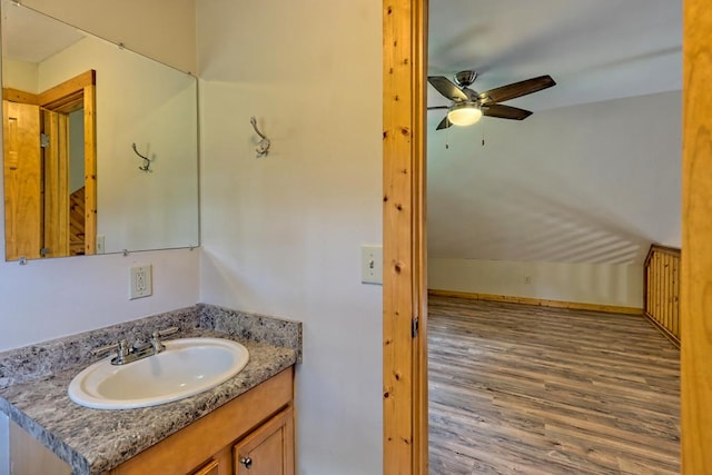 bathroom with ceiling fan, vanity, and wood-type flooring