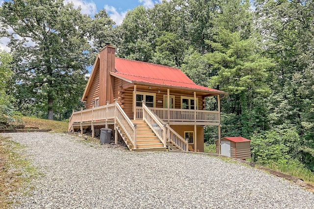 log home featuring a shed