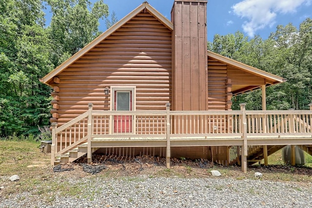 view of property exterior with a wooden deck