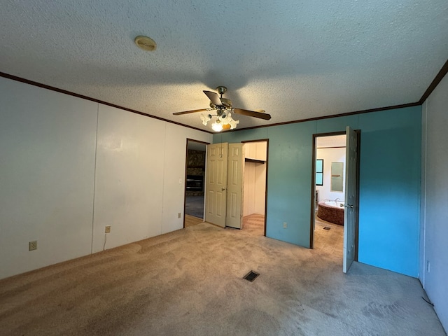 1146 Marrestop Rd, Murphy, NC 28906 - unfurnished bedroom featuring crown molding, light carpet, a textured ceiling, ensuite bath, and a ceiling fan