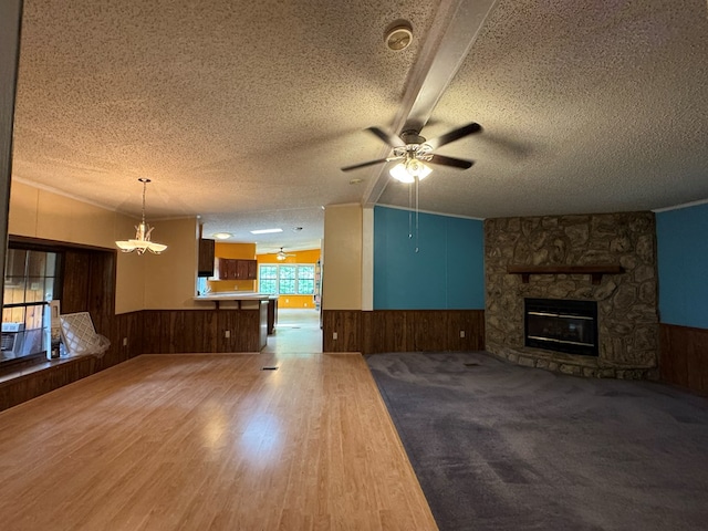 1146 Marrestop Rd, Murphy, NC 28906 - unfurnished living room featuring a wainscoted wall, wooden walls, a textured ceiling, a ceiling fan, and a fireplace