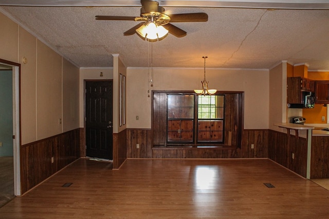 1146 Marrestop Rd, Murphy, NC 28906 - unfurnished dining area with wainscoting, wood finished floors, wooden walls, a textured ceiling, and a chandelier