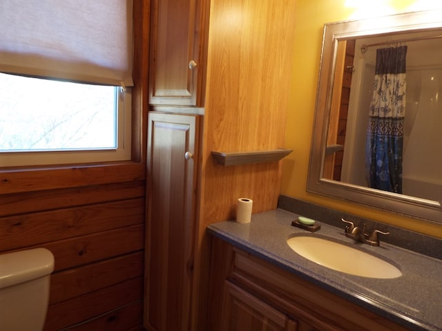 full bathroom featuring curtained shower, vanity, and toilet