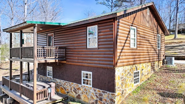 view of side of home featuring central AC