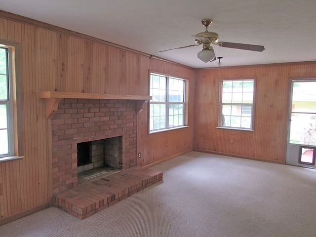 138 Brittain Trce, Andrews, NC 28901 - unfurnished living room with wood walls, a ceiling fan, baseboards, carpet, and a fireplace