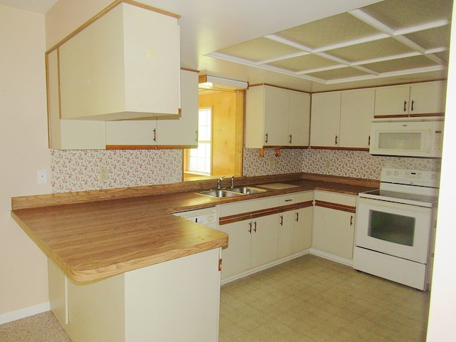 138 Brittain Trce, Andrews, NC 28901 - kitchen with white appliances, a sink, a peninsula, tasteful backsplash, and light floors