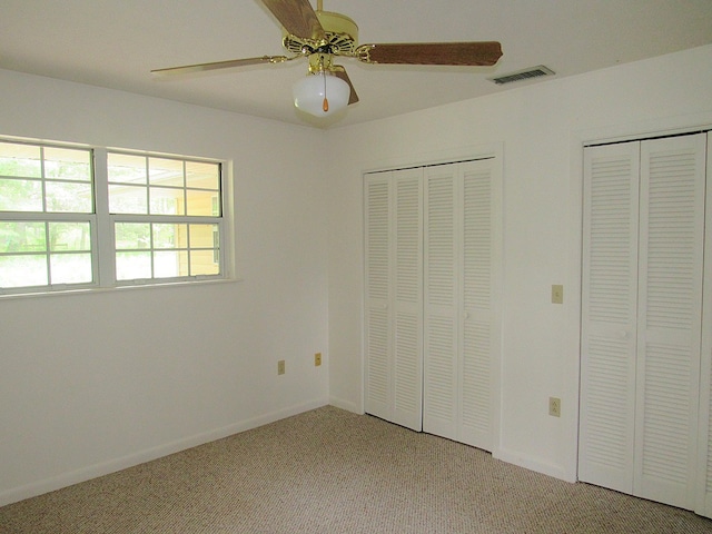 138 Brittain Trce, Andrews, NC 28901 - unfurnished bedroom featuring multiple closets, light colored carpet, baseboards, and ceiling fan
