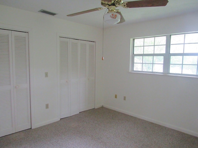 138 Brittain Trce, Andrews, NC 28901 - unfurnished bedroom featuring multiple closets, light carpet, baseboards, and ceiling fan
