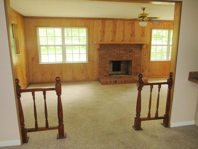 138 Brittain Trce, Andrews, NC 28901 - unfurnished living room featuring carpet, ceiling fan, healthy amount of natural light, baseboards, and wood walls