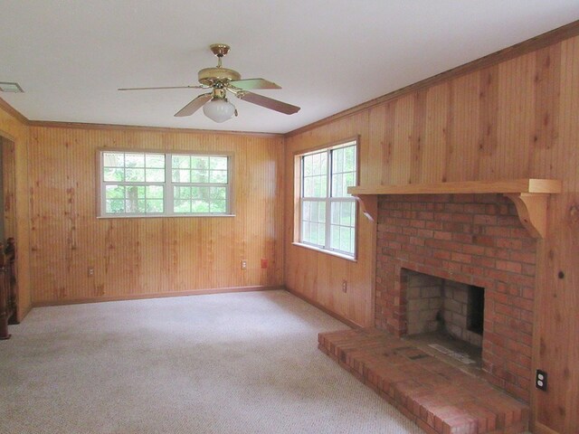 138 Brittain Trce, Andrews, NC 28901 - unfurnished living room featuring healthy amount of natural light, wood walls, ceiling fan, baseboards, and a brick fireplace