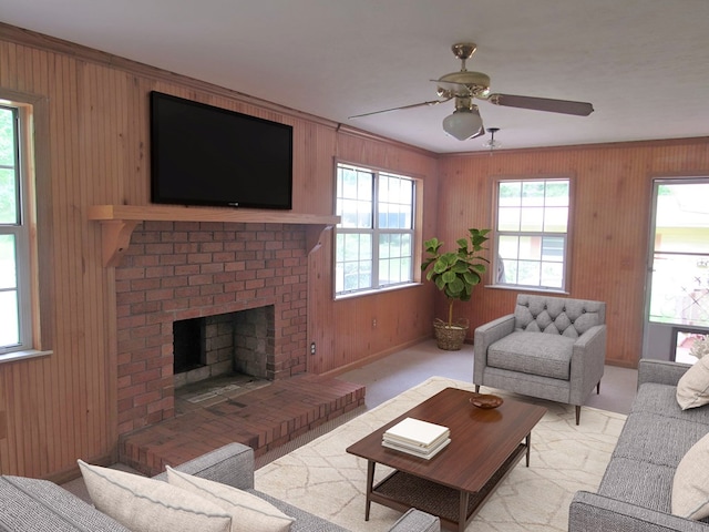 138 Brittain Trce, Andrews, NC 28901 - living area with a ceiling fan, wood walls, a fireplace, baseboards, and crown molding