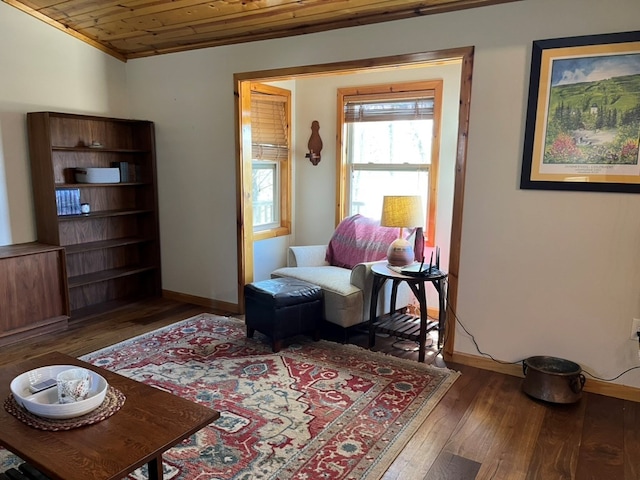 sitting room featuring baseboards, wood ceiling, and hardwood / wood-style floors