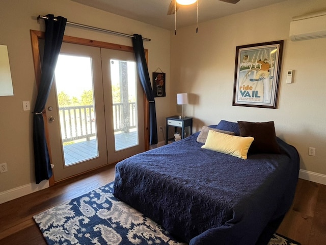 bedroom with access to exterior, baseboards, wood finished floors, and a wall mounted air conditioner