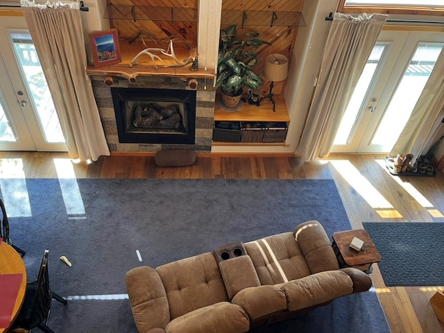 living room featuring french doors, wood finished floors, and a fireplace