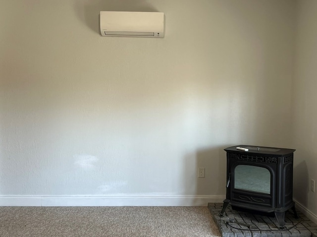 room details with a wall mounted air conditioner, a wood stove, baseboards, and carpet floors