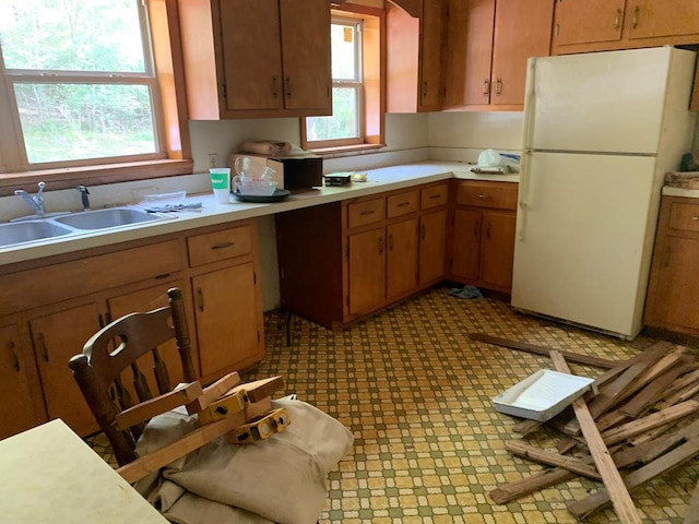 kitchen featuring sink and white fridge