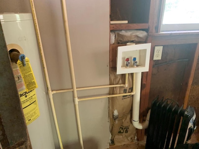 utility room featuring radiator and gas water heater