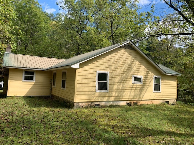 view of side of home with a lawn