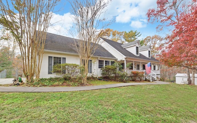 cape cod house with a front lawn and a porch