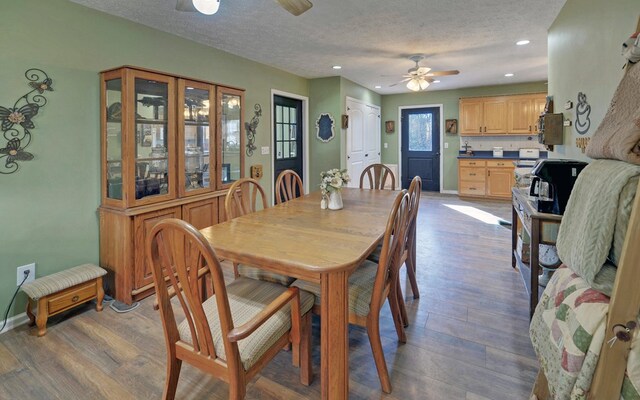 dining space featuring ceiling fan, hardwood / wood-style floors, and a textured ceiling